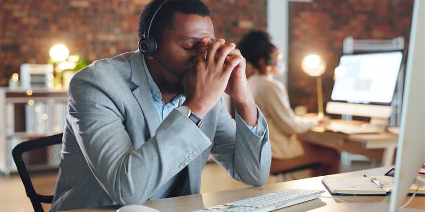 Man, call center and stress by computer, tired or mistake for tech support, glitch or error. Consultant, crm or agent in night, telemarketing or customer service with fatigue