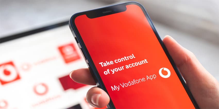 My Vodafone app. Mobile phone in woman hand with title screen of mobile network