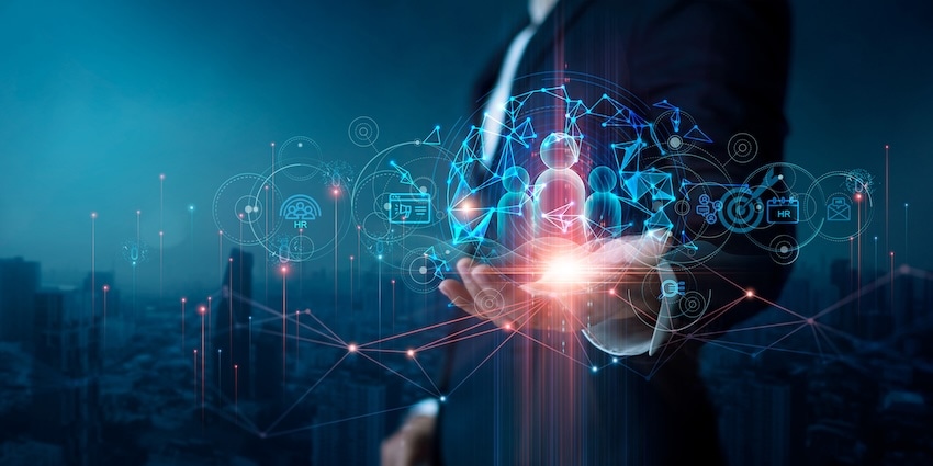 Digital illustration of workforce technology icons above a businessperson’s hand, representing modern workforce engagement management
