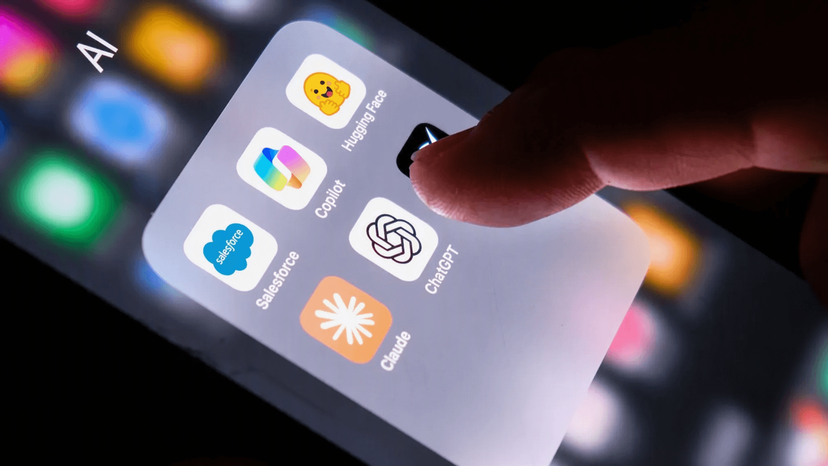 Smartphone displaying AI assistant apps including Gemini, Copilot, DeepSeek, ChatGPT and Claude